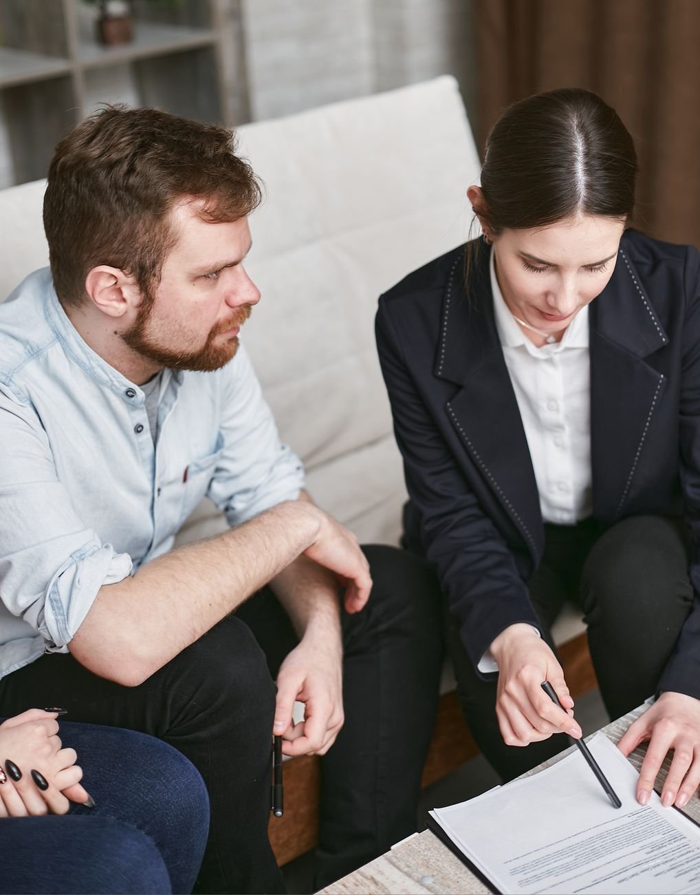Business professionals in a meeting reviewing documents in a professional setting.